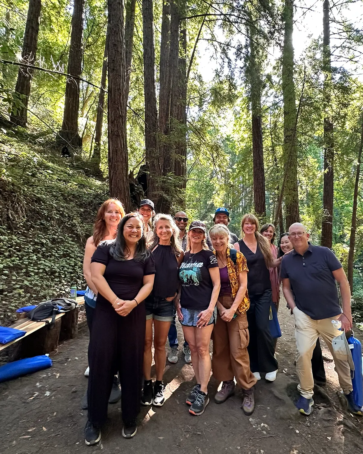 A group of people posing after completing various day retreat exercises, forest bathing and more